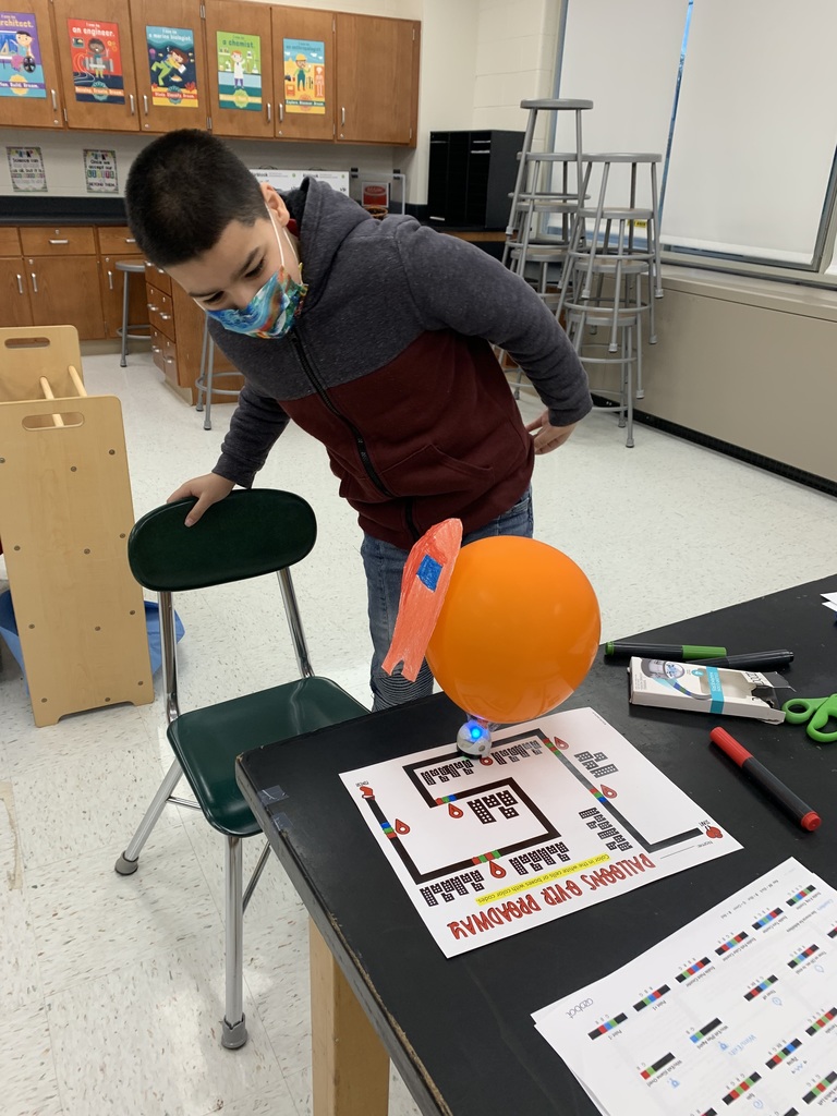 Student watching his ozobot float travel down Broadway