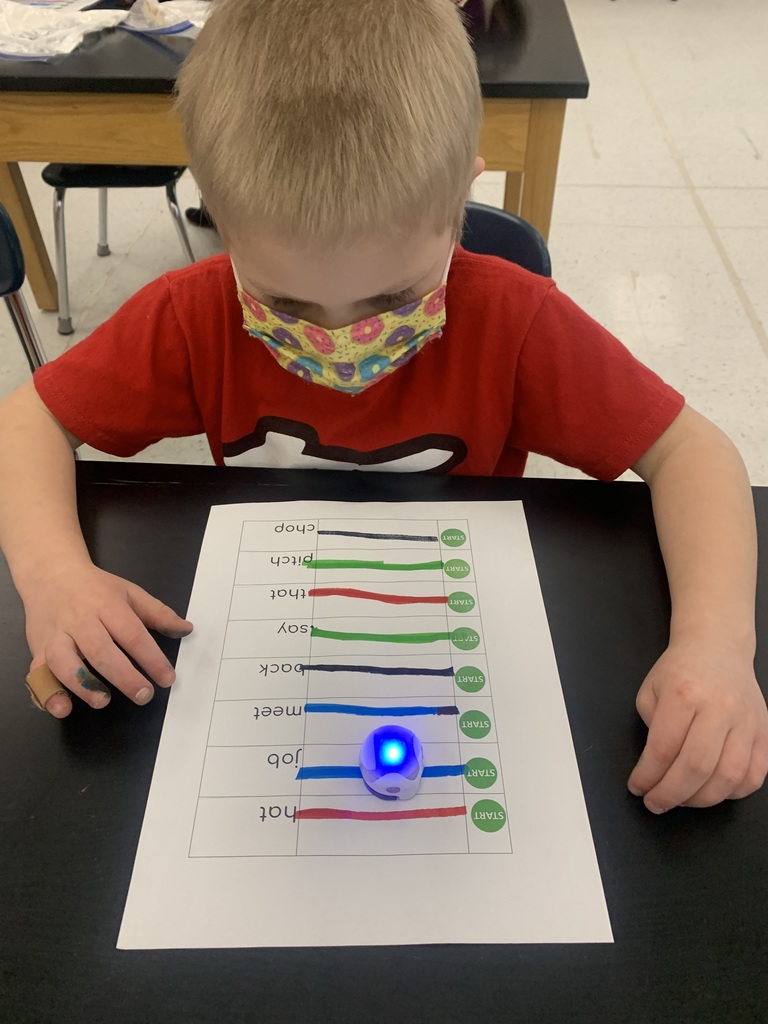 Student watching ozobot move to a word.