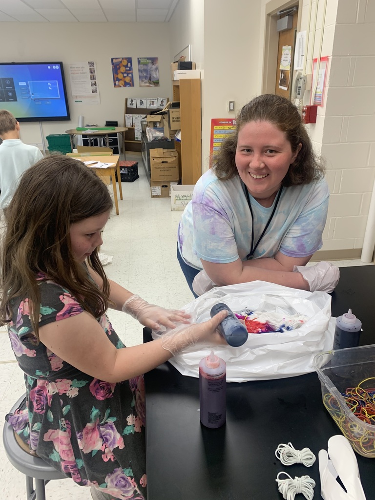 Miss Glasier tie dying with a student.