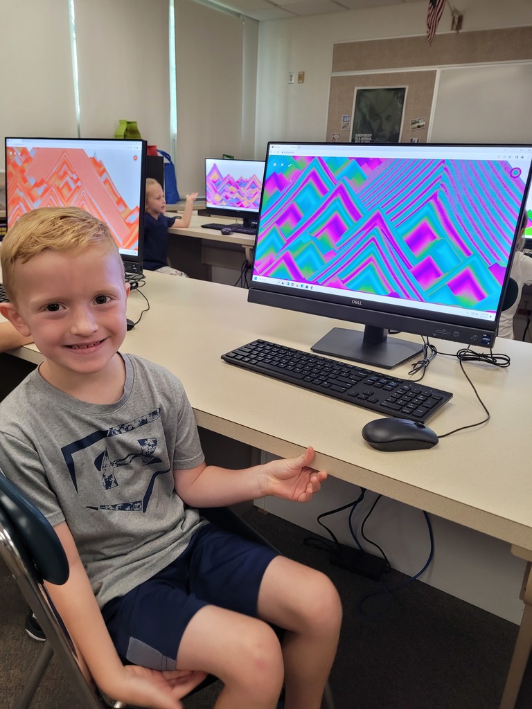 boy sits by computer
